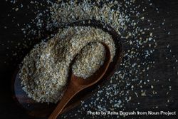 Ground oats with wooden spoon on counter 5oD6Kz
