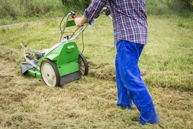 man mowing the lawn with a lawnmower