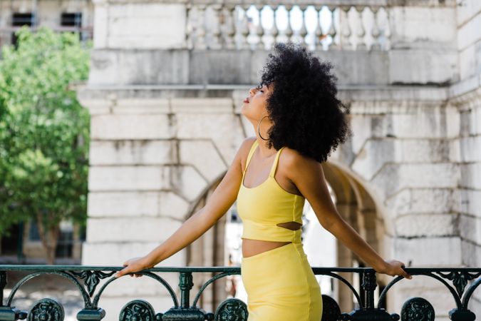 Stylish female leaning on railing outdoors