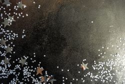 Christmas card concept of silver stars on table with copy space