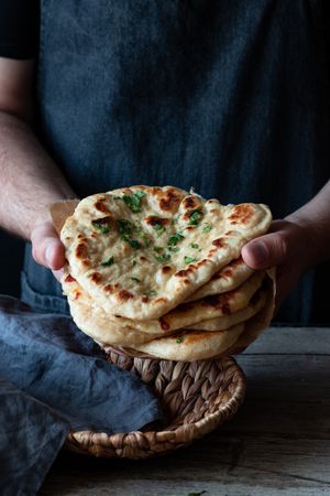 Crop man demonstrating naan bread