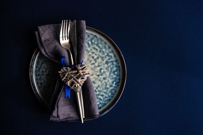 Valentine day table setting with blue plate and heart decoration