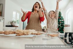 Mother and daughter having fun while baking for the holidays 0LdaAr