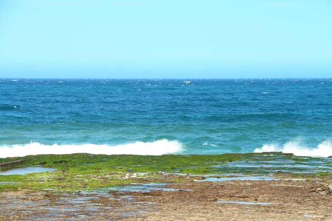 Peaceful Ocean With Waves Crashing Against The Shore And Distant View Of The Horizon