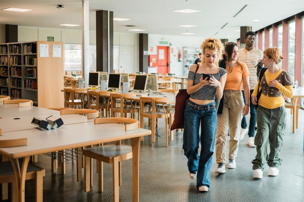 Diverse students leaving library together