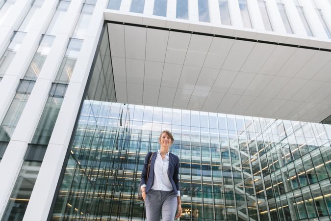 Happy female manager walking from work