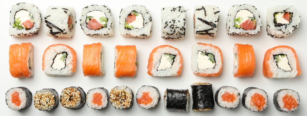 Flat lay with sushi rolls on blank background. Japanese food