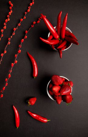 Cloth and branches near peppers and strawberries