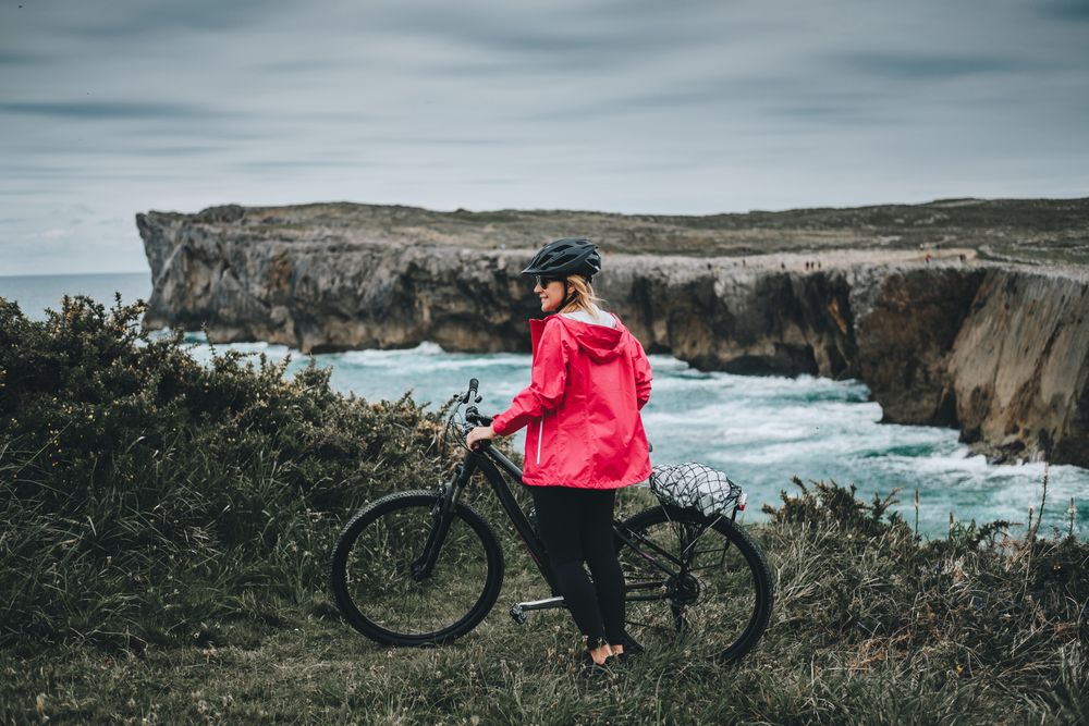 Female bicyclist on rocks
