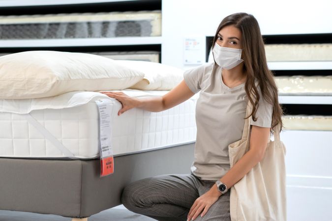 Woman in furniture store wearing surgical mask