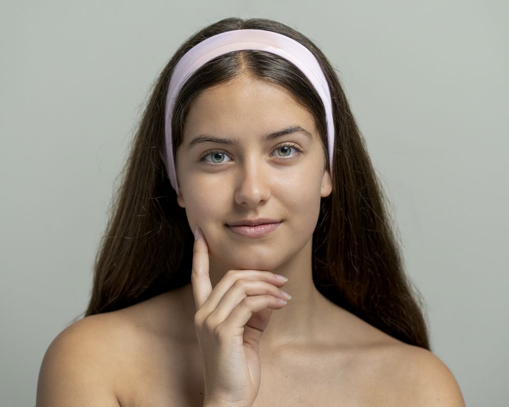 Natural beauty and healthy skin in skincare concept; beauty portrait of young woman with direct gaze.