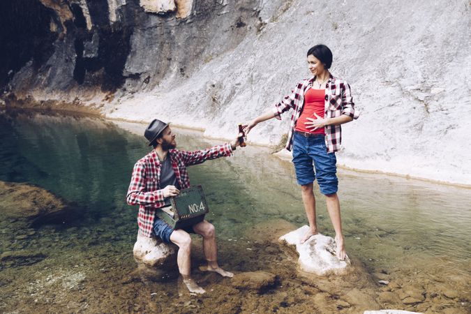 Couple with beer chilling on lake