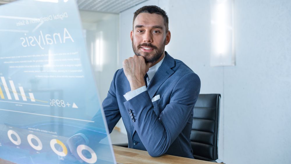 In the Near Future Successful Businessman Works on Computer