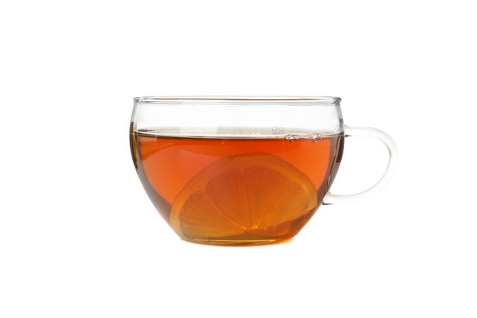 Tea with lemon slice isolated on bright background