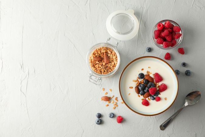 Flat lay composition with parfaits dessert and ingredients on cement background
