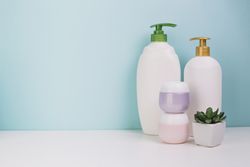 Potted plant near cosmetics and plastic bottles