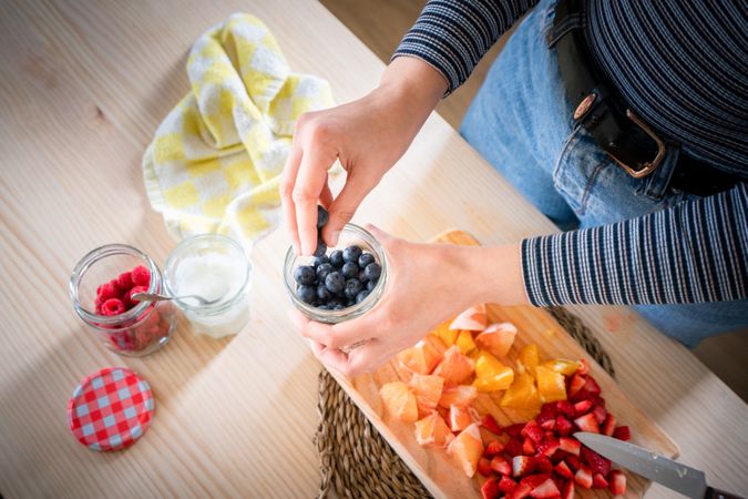 Crop woman preparing healthy food