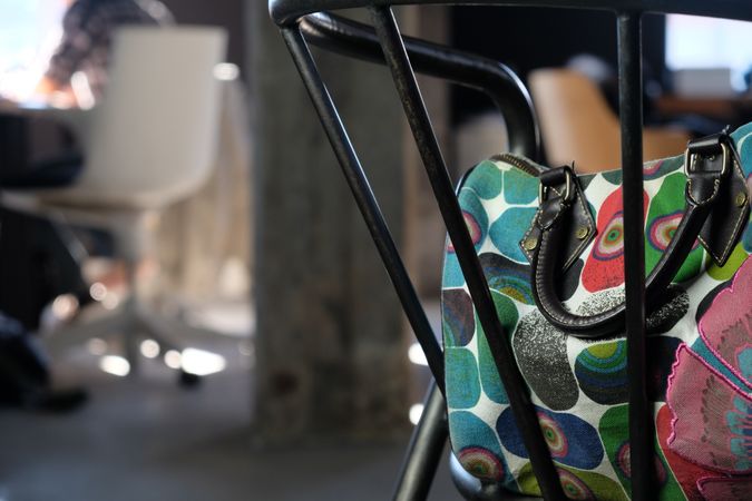 Colorful handbag on chair in office with copy space