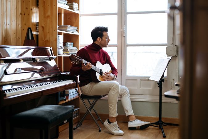 Man playing guitar in studio