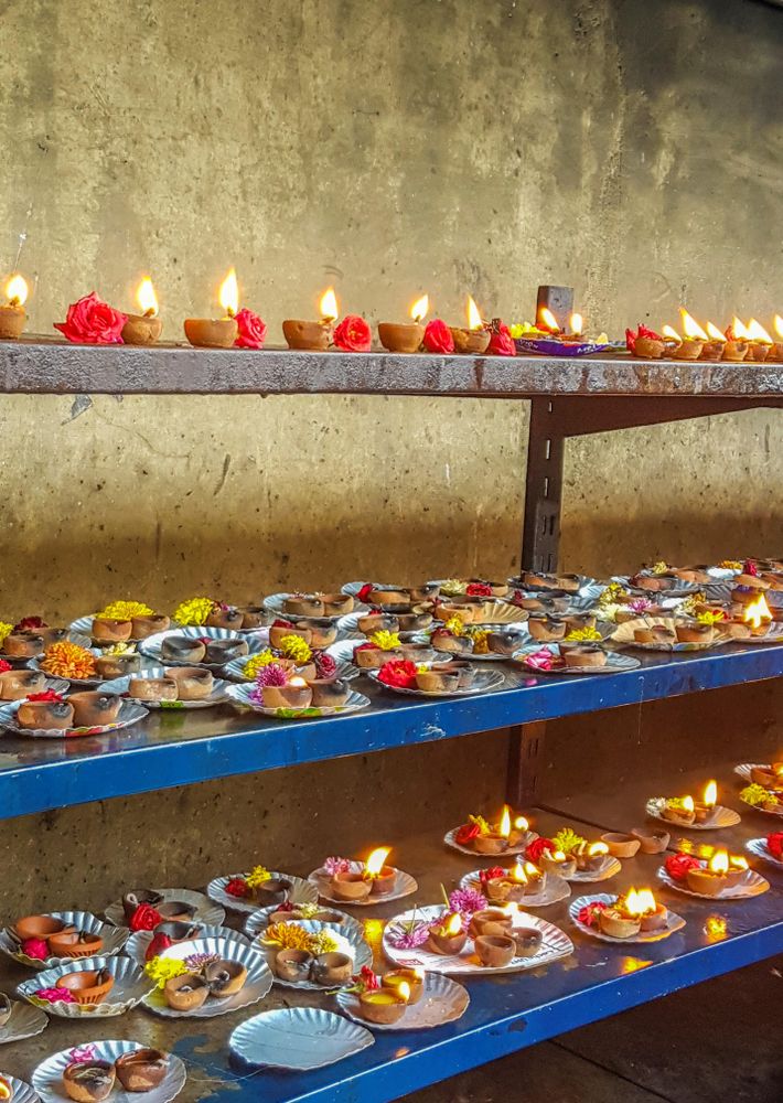 Assorted Diwali's desserts with diyas on shelves outdoor