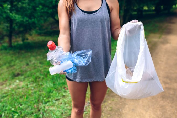 Unrecognizable woman showing garbage