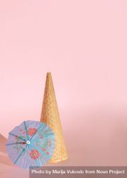 Cone of ice cream with blue cocktail parasol 5alNQ0