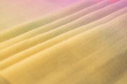 Gradient colorful folded fabric background texture. blue yellow and green.