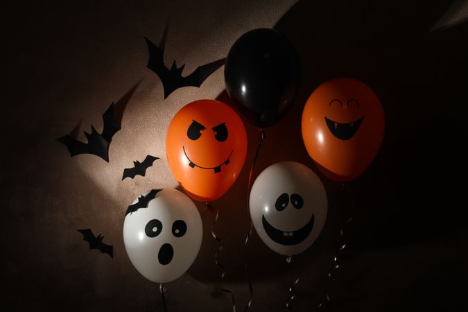 Different balloons on dark background. Halloween concept