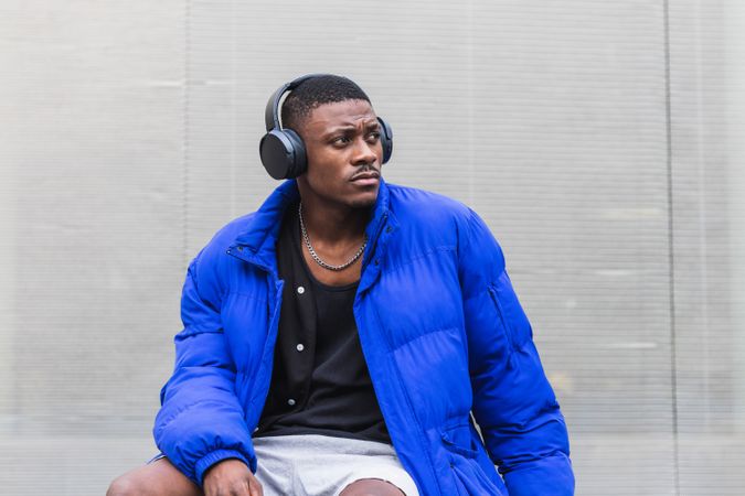 Black man listening to music in city