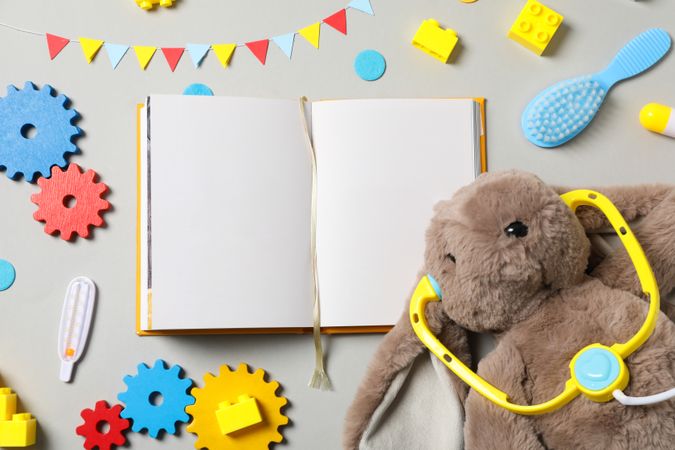 A children's book with toys on a light background.