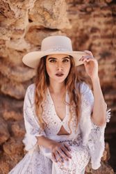 female sitting by ruined wall