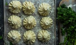 Top view of trey of Georgian khinkali dumplings with cilantro garnish