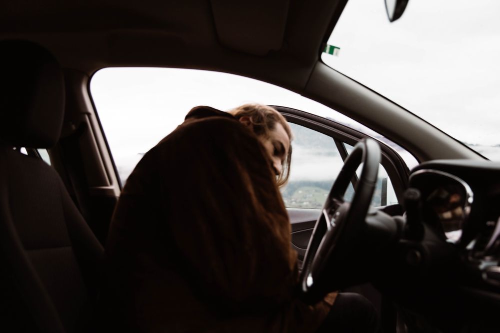 Cold male traveler sitting in car