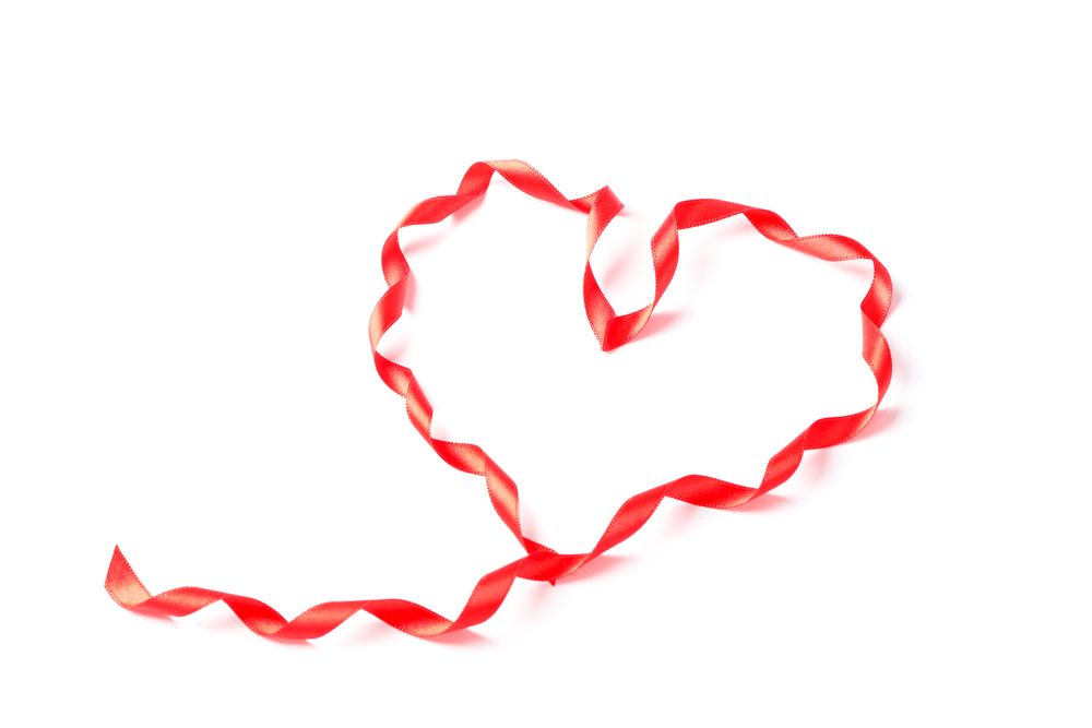 Red ribbon heart isolated on blank background
