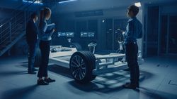 Automobile Engineers Working on Electric Car Platform Chassis, Using Tablet Computers with CAD Software for 3D Concept