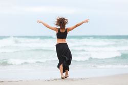 woman dancing near sea