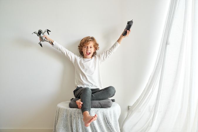 Excited preteen boy joying new drone with remote control