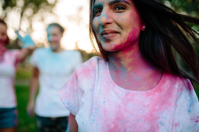 Young woman face smeared with colors