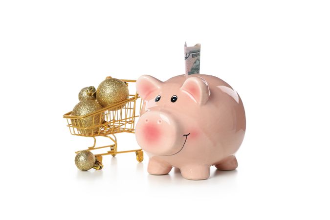 Concept of Christmas finance with piggy bank, isolated on light background