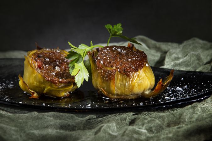 Delicious baked artichokes on plate
