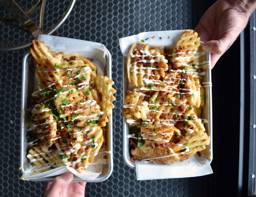 Top view of two hands holding fries