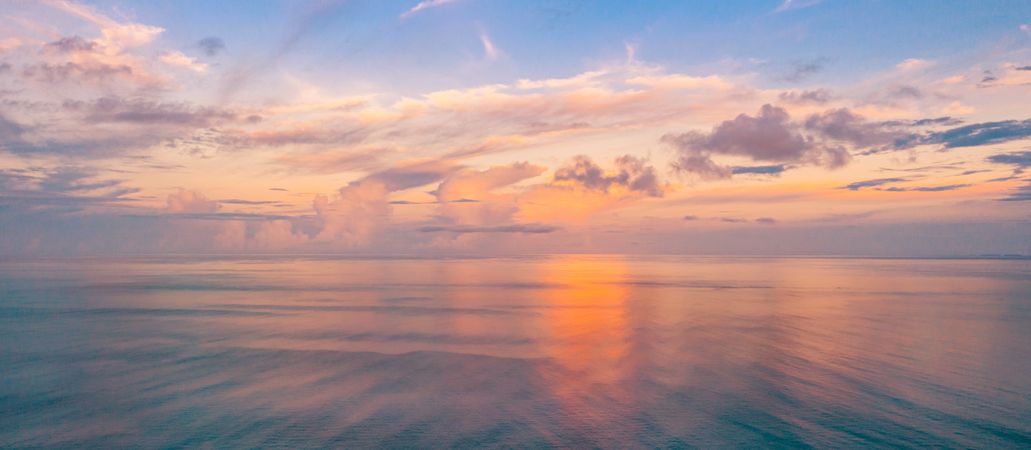 Wide shot of sunset looking out over the ocean