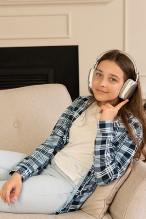 Teen girl enjoying music at home.