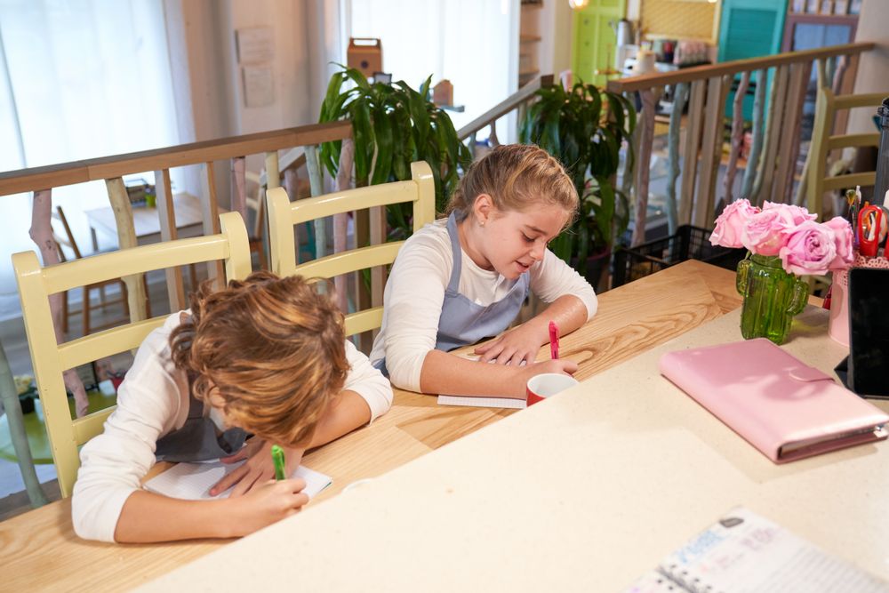 Cute kids painting on papers in creative studio