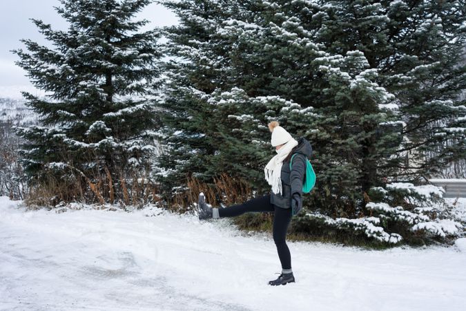 Young woman playing with snow