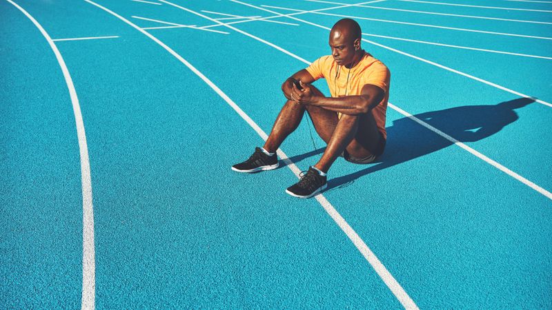 Athlete sitting looking serious on a race track