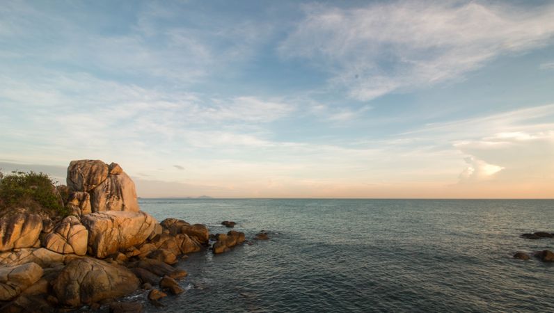 Rock formation on sea under blue sky in East Bintan, Riau Islands, Indonesia