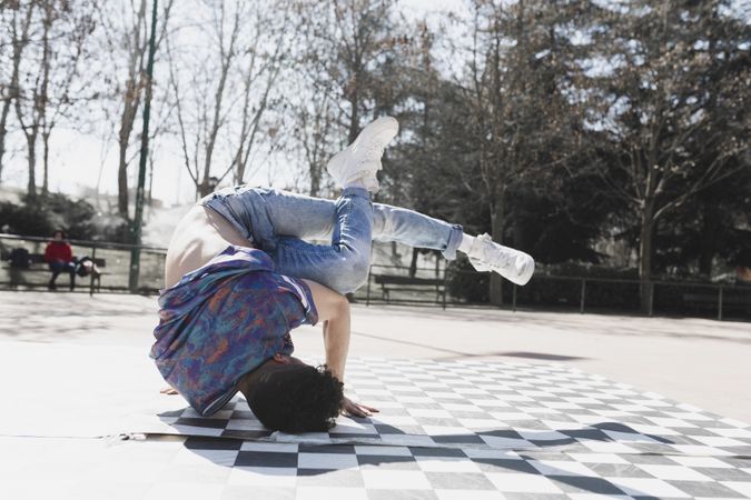 Man dancing break dance in park