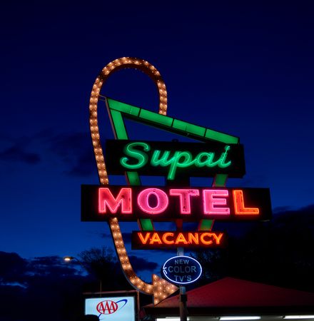 Retro neon sign for Supai Motel at dusk in Arizona