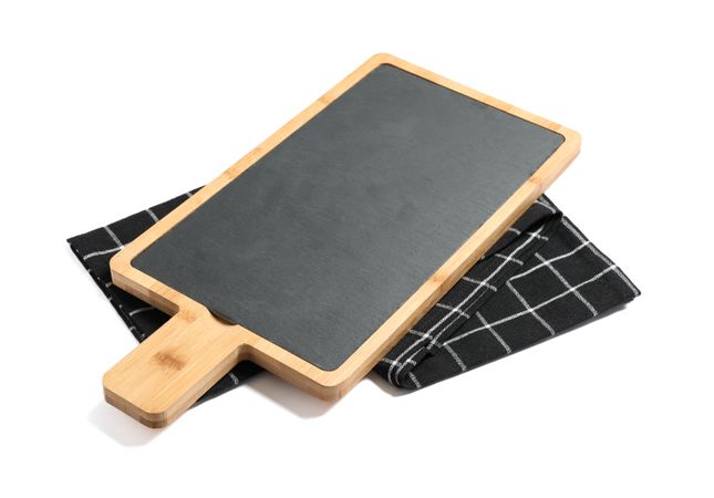 Cutting board with kitchen towel isolated on plain background